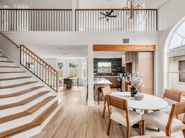 Light hardwood stairs and dining area in Austin